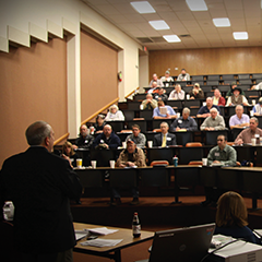 people meeting in large forum