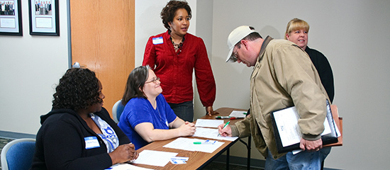 Staff at display table talking to the public